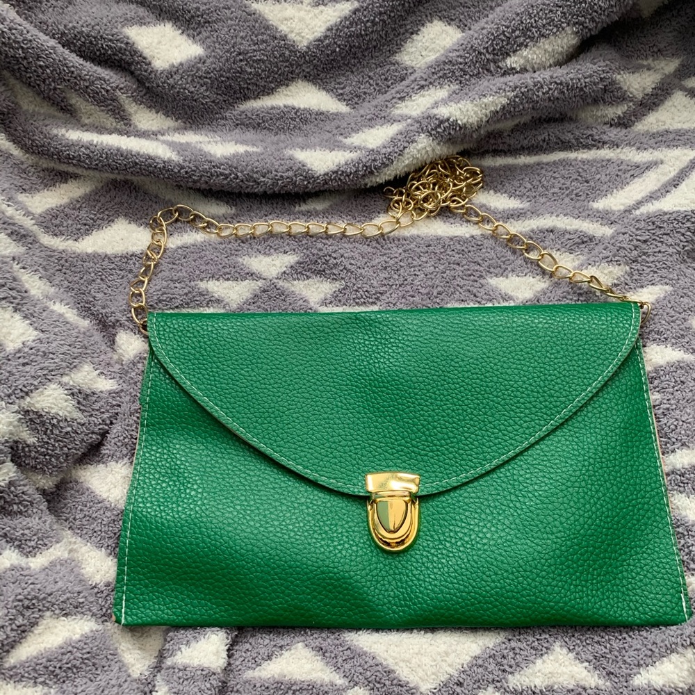 Green envelope purse with gold chain.